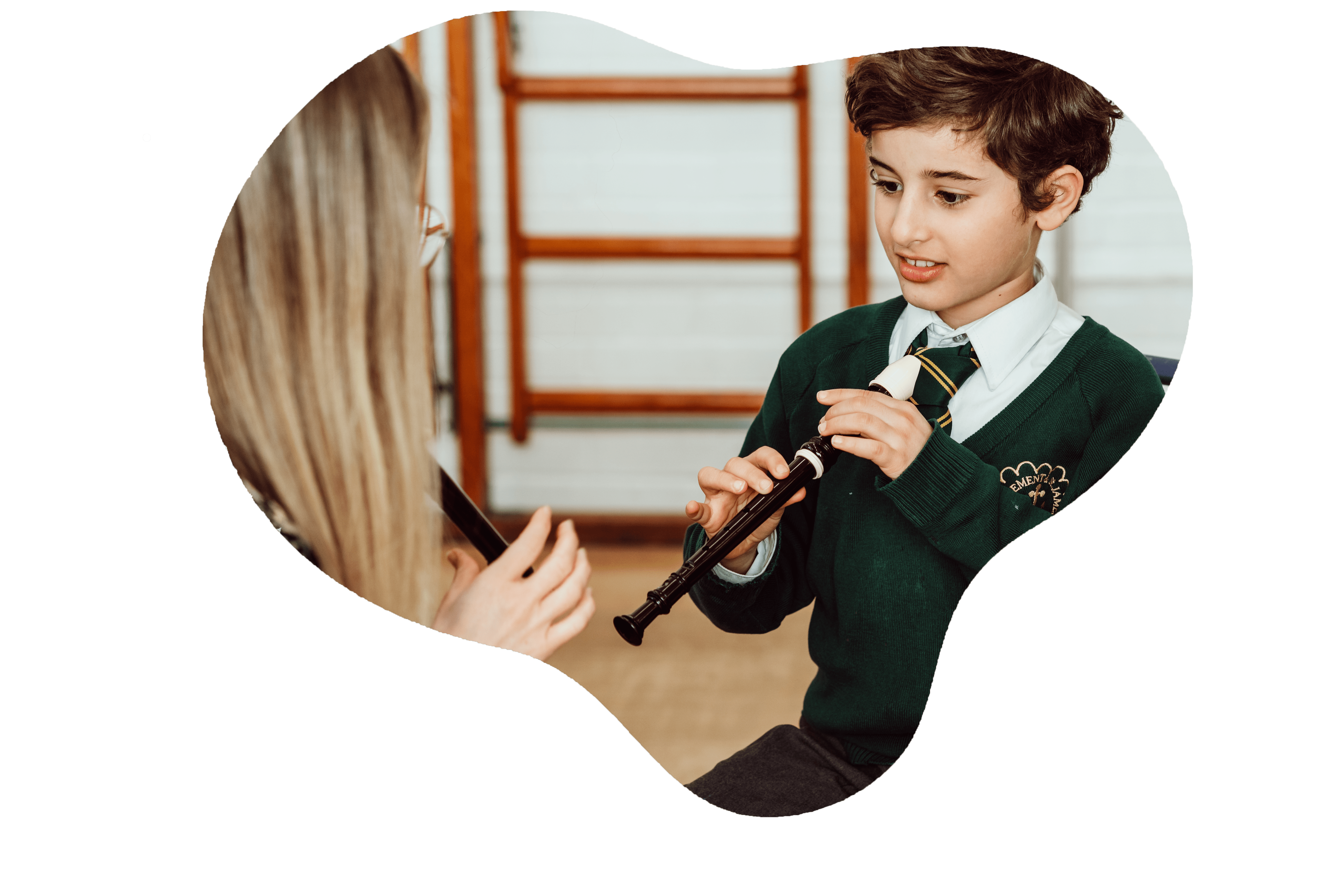 female music teacher teaching a student the recorder