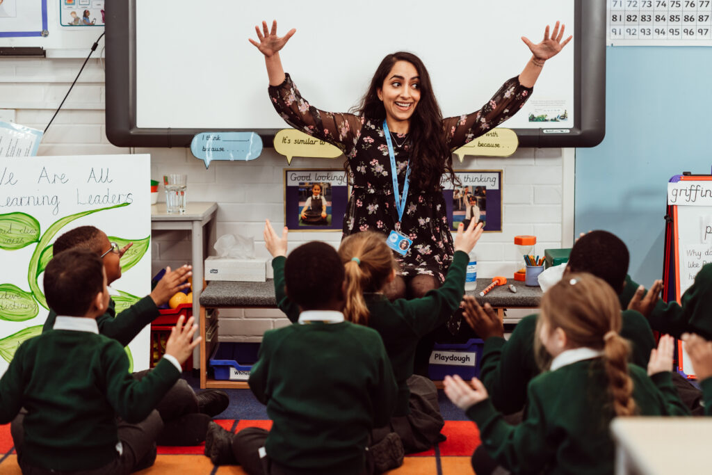 A Sing Education specialist is delivering a joyful singing lesson and singing an action song