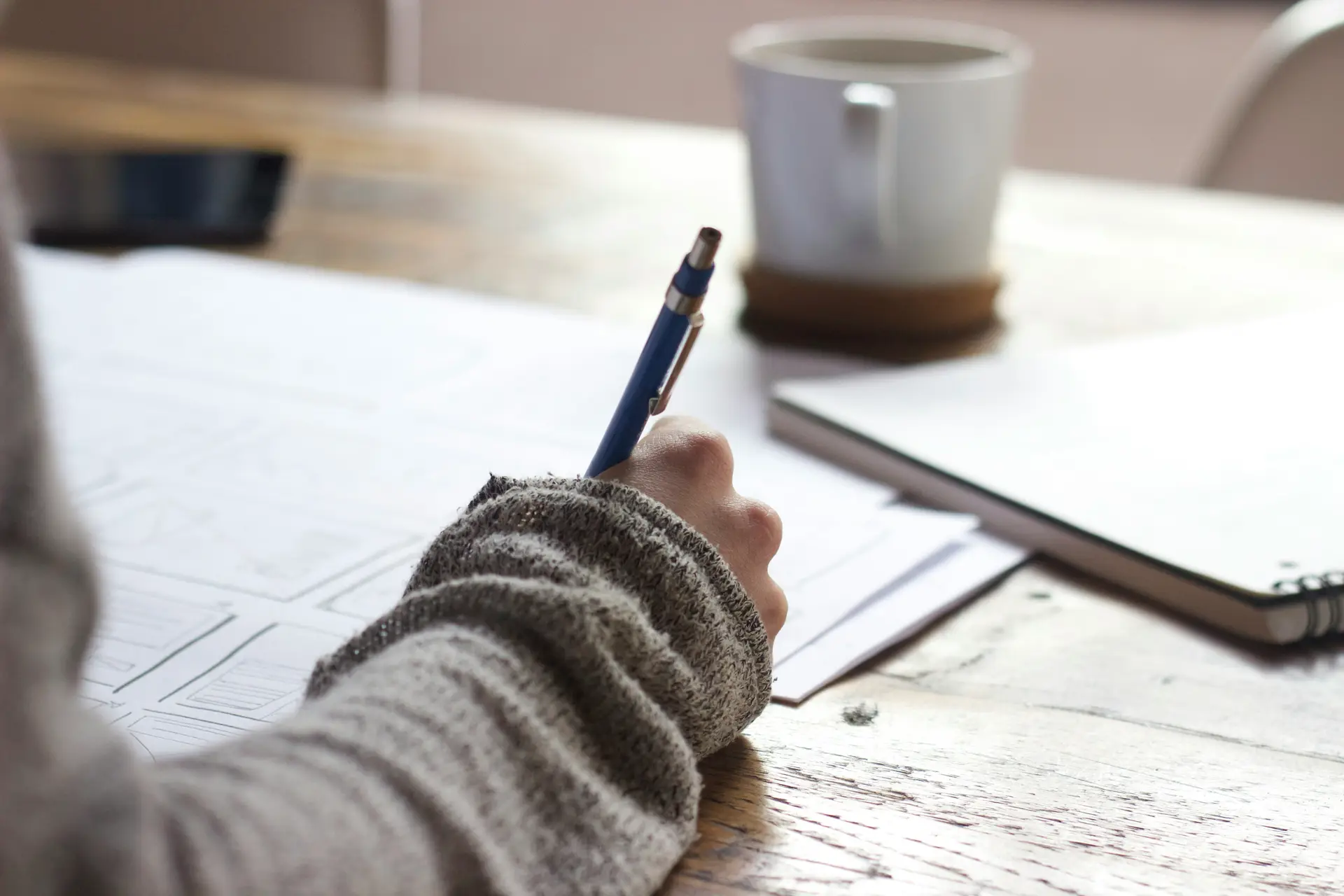 A student is taking an exam. The photo is a close up of their pen writing on the page